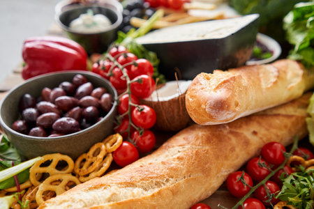 Baguette. Fresh bread, pastries. Table full of mediterranean appetizers, tapas or antipasto. Assorted Italian food set. Delicious snack on party or picnic time. Italian style banquet.の写真素材