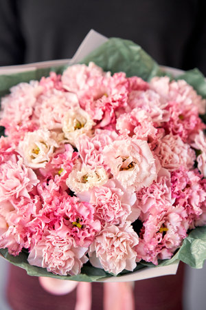 Beautiful bouquet of mixed flowers in woman hand. Floral shop concept . Beautiful fresh cut bouquet. Flowers deliveryの写真素材