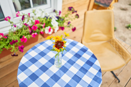 Table with flowers in a vase. Flower field on the sunny morning. Beautiful flower seedlings growing in the soil at the garden. Gardening hobby concept.の写真素材