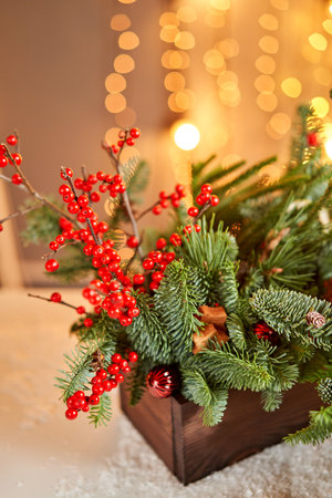 Floral arrangement in a wooden box with live spruce and ilex branches for decorating the house for the Christmas holidays.Christmas wooden box with fir branches for the holiday. The new year celebration. European flower shopの写真素材