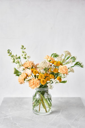 Finished flower arrangement in a vase for home. Flowers bunch, set for interior. Fresh cut flowers for decoration home. European floral shop. Delivery fresh cut flower.の写真素材