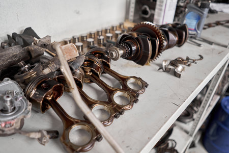 Many tools and auto spare parts car at a car repair shop. Car parts for repairs. Used vehicle part...