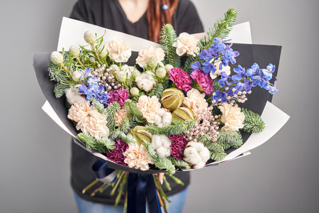 Large Beautiful bouquet of mixed flowers in woman hand. Floral shop concept . Beautiful fresh cut bouquet. Flowers deliveryの写真素材