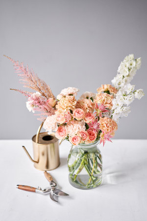 Finished flower arrangement in a vase for home. Flowers bunch, set for interior. Fresh cut flowers for decoration home. European floral shop. Delivery fresh cut flower.の写真素材