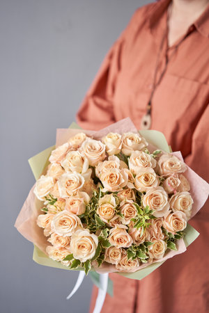 Beautiful mono bouquet of flowers in woman hand. Floral shop concept . Beautiful fresh cut bouquet. Flowers deliveryの写真素材