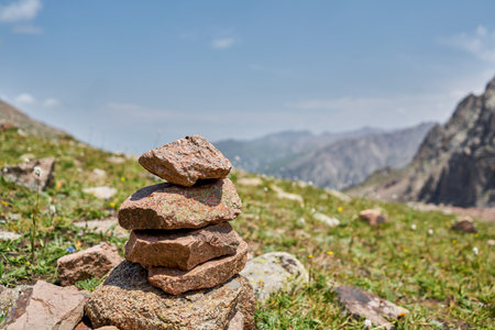 Zen balanced stones stack in high mountains. Pyramidal of stones against the backdrop of a picturesque mountain valley. Moraine in the highlands of Kazakhstan.の写真素材
