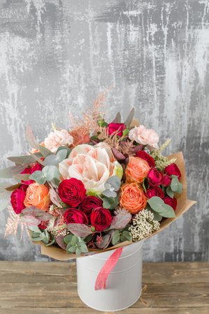 Small Beautiful bouquet of mixed flowers in woman hand. Floral shop concept . Beautiful fresh cut bouquet. Flowers deliveryの写真素材