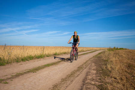 Henchie rides a bicycle on a country roadの写真素材
