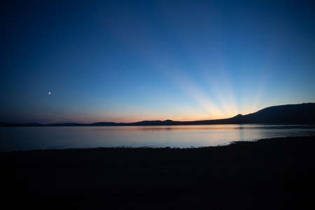 Stunningly beautiful sunset on a mountain lakeの写真素材