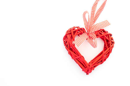 Bright red wicker heart on a solid white backgroundの写真素材