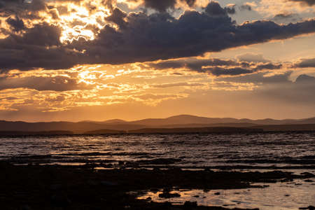 Mountain lake at sunset. The yacht sways on the wavesの写真素材