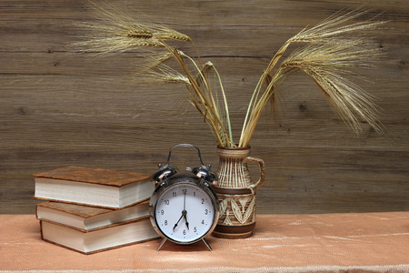Alarm clock and a vase with earsの写真素材