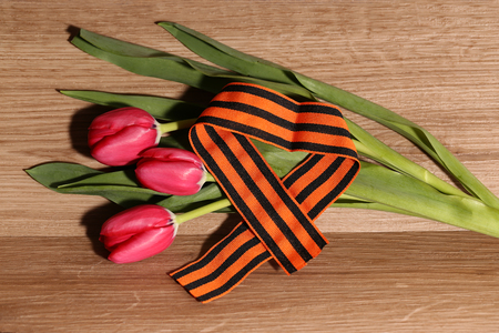 Victory Celebration / Red tulips wrapped in tapeの写真素材