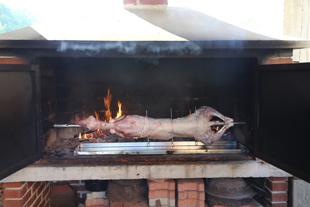 The carcass of the goat is fried on a spitの写真素材