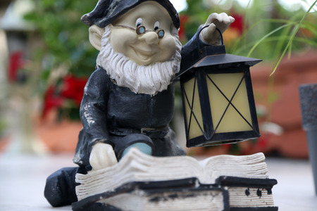 Gnome. Beautiful garden gnome with a lanternの写真素材