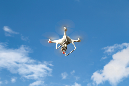 A flying drone armed with camera.