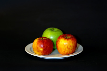 Fresh apples on a saucerの写真素材