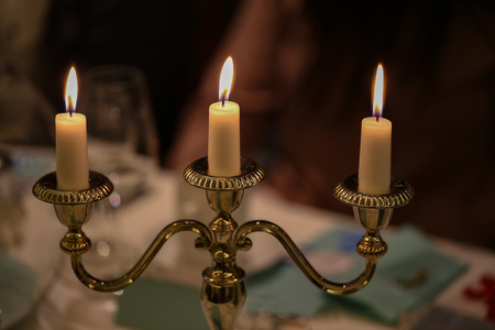 Burning candles on a blurred backgroundの写真素材