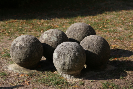 Old stone cannonballs lying on the groundの写真素材