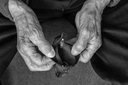 Pension / Empty wallet in the hands of an old manの写真素材