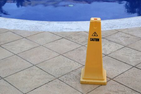 Yellow column near the pool, warns of dangerの写真素材