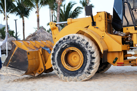 Morning on the beach of Bavaro (Dominican Republic) / Cleaning the beach with a tractorの写真素材