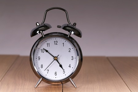 The old alarm clock on a light background.の写真素材