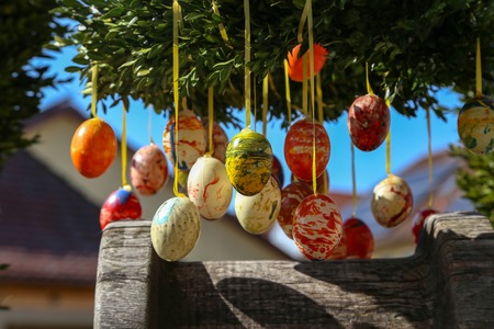 Easter eggs on a fountain in the city.の写真素材