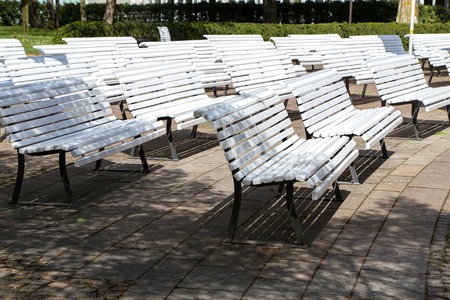 White benches on the concert stage at the Park.