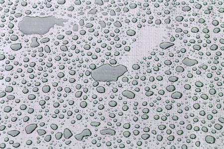 Large drops of water on the plastic film after the rain