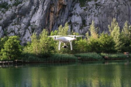 Drone flies low above water on lake.