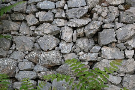 Grey stone wall. Wall made of natural stone.