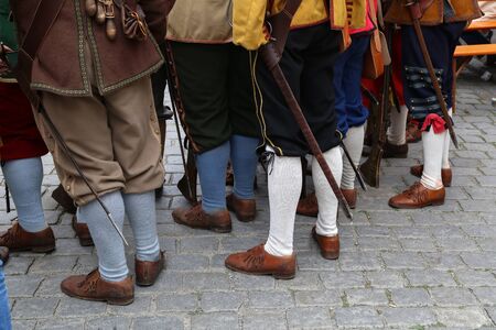 Reconstructors in musketeers clothes on a city holiday.の写真素材