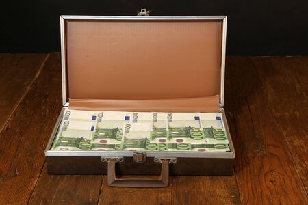 Case full of money standing on the table.