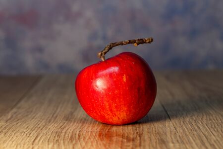 Beautiful red apple lies on the table.