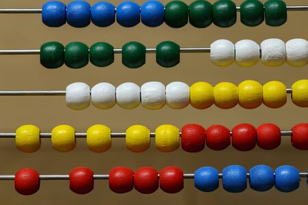 Children's colorful abacus for counting with multi-colored wooden beads.