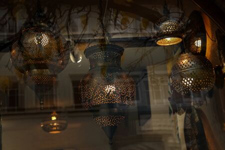 Reflection in the glass shop window of electric lights.の写真素材