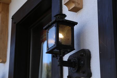 Glowing street lamps on the facade of houses.の写真素材
