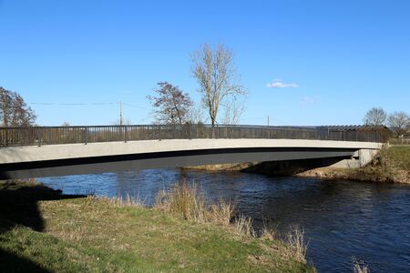Bridge over a small river in spring.