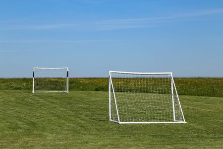 Football goal stand on a green lawn.の写真素材