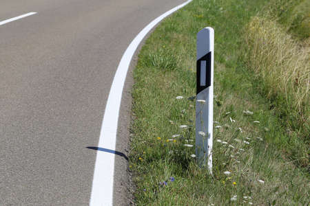 Roadside post on a country road in Germany.