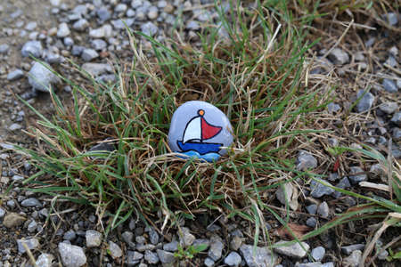 The painted hiking stone is left on the walking path for passersby to see.の写真素材