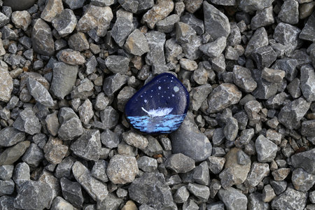 The painted hiking stone is left on the walking path for passersby to see.の写真素材