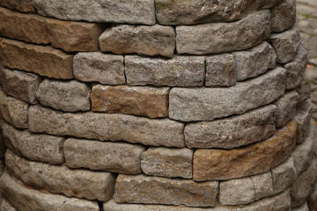 Gray stone wall made of natural stone. Textural decorative wall made of stone. Natural stone background.の写真素材