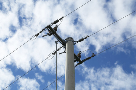Power transmission masts against a blue sky.