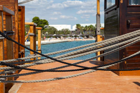 Close-up of used vintage marine ropes on old sailing vessel.の写真素材