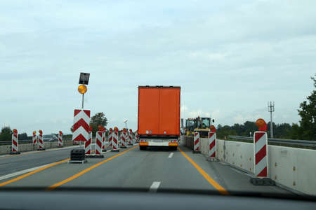 A truck drives through a construction site on the motorway