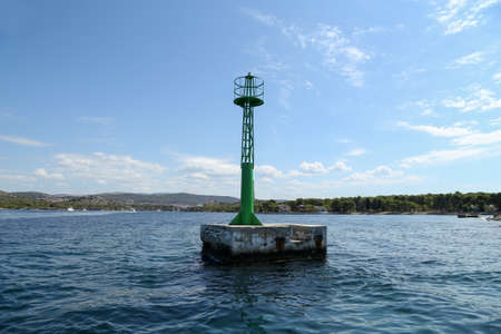 Lighthouse on the water indicates shallow water.の写真素材