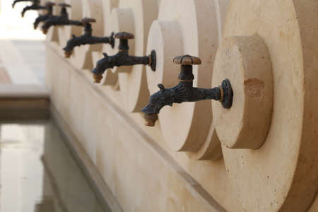 A close up of a row of water taps.の写真素材