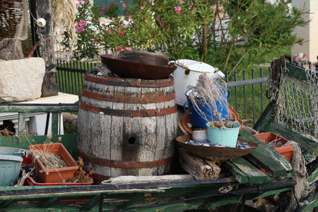 An old barrel, dishes and other junk used as decoration